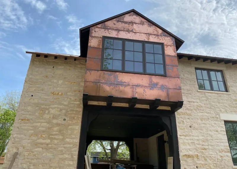 Copper metal panel facade on a stone building for Skylight Installation in Blythe